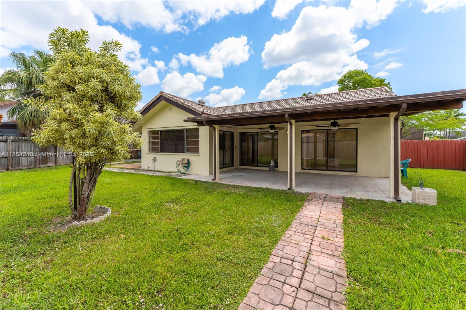 9130 Southwest 101st Avenue Miami, FL 33176 - Photo 29 of 35 a front view of a house with a garden and yard