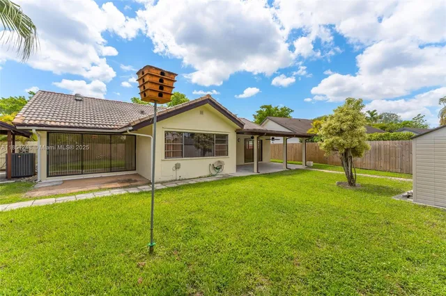 a front view of a house with a garden and yard