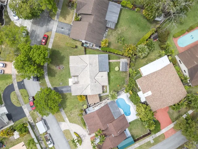 an aerial view of a house with a yard and garden