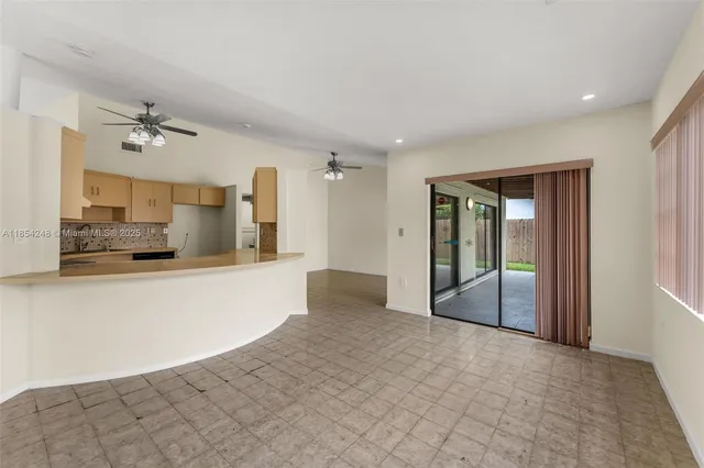 a view of a kitchen with a sink and a refrigerator