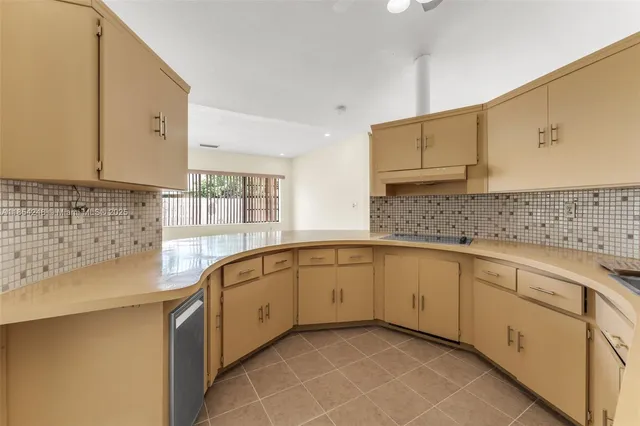 a kitchen with granite countertop a sink stove and cabinets