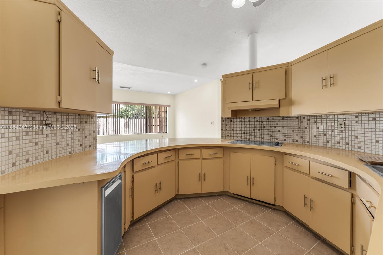 9130 Southwest 101st Avenue Miami, FL 33176 - Photo 9 of 35 a kitchen with granite countertop a sink stove and cabinets