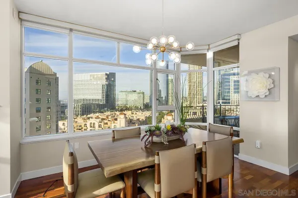 a view of a dining room with furniture a chandelier and wooden floor