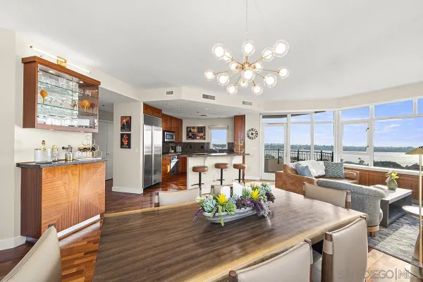 a living room with kitchen island furniture and a chandelier