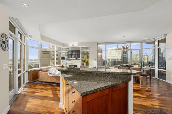 a view of a kitchen with kitchen island granite countertop a large window