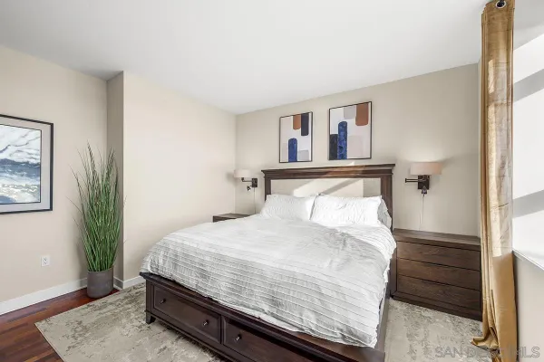 a bedroom with a bed and a television