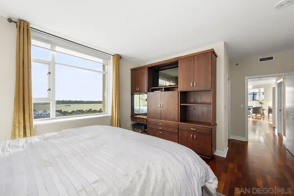 a bedroom with a bed and lamp