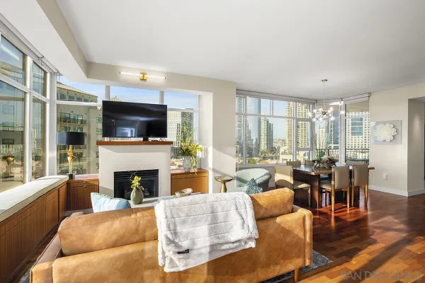 a living room with furniture a fireplace and a flat screen tv