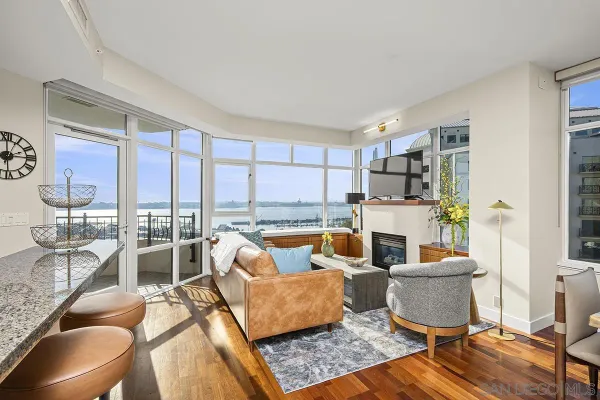 a living room with fireplace furniture and a large window