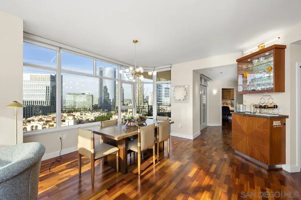 a room with lots of wooden furniture and large windows