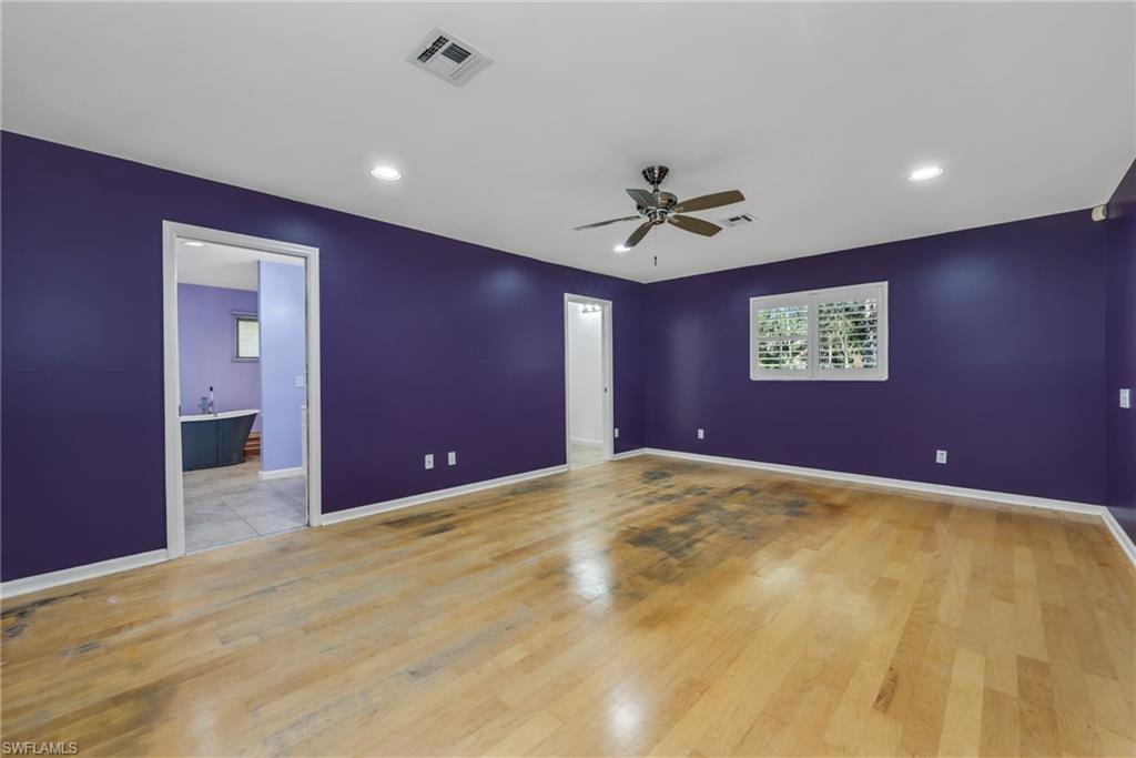 5191 Mahogany Ridge Drive Naples, FL 34119 - Photo 11 of 18 a view of an empty room with a ceiling fan and window