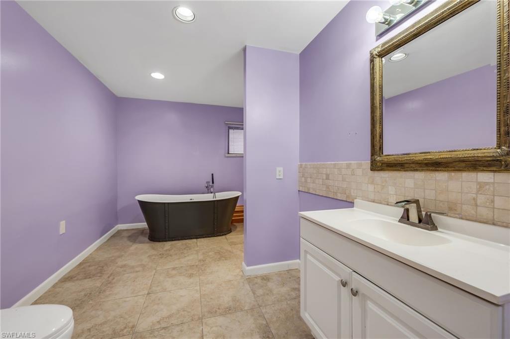 5191 Mahogany Ridge Drive Naples, FL 34119 - Photo 12 of 18 a bathroom with a sink and a mirror