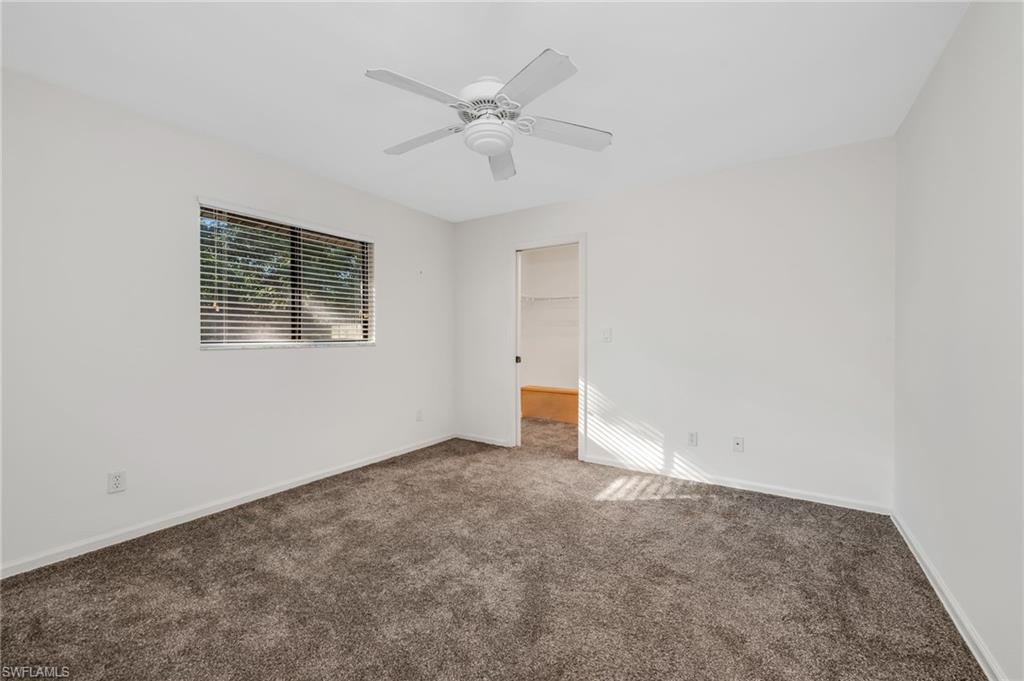 5191 Mahogany Ridge Drive Naples, FL 34119 - Photo 14 of 18 an empty room with a ceiling fan and a window
