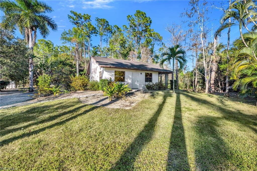 5191 Mahogany Ridge Drive Naples, FL 34119 - Photo 5 of 18 a view of swimming pool with a garden