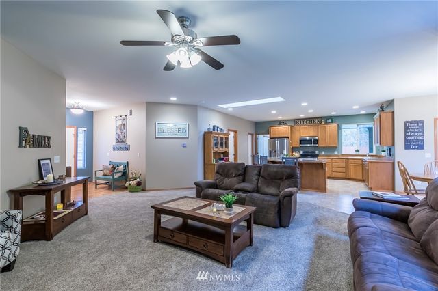 a living room with furniture and kitchen view