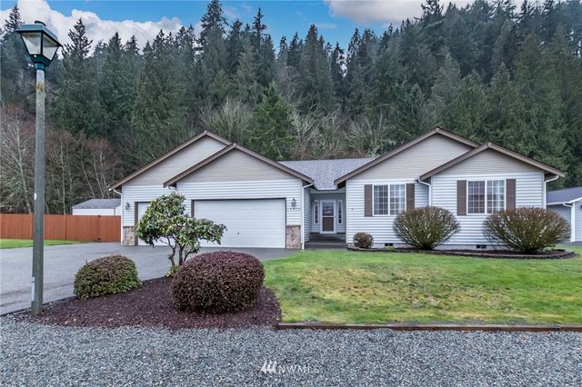 a front view of a house with yard and green space