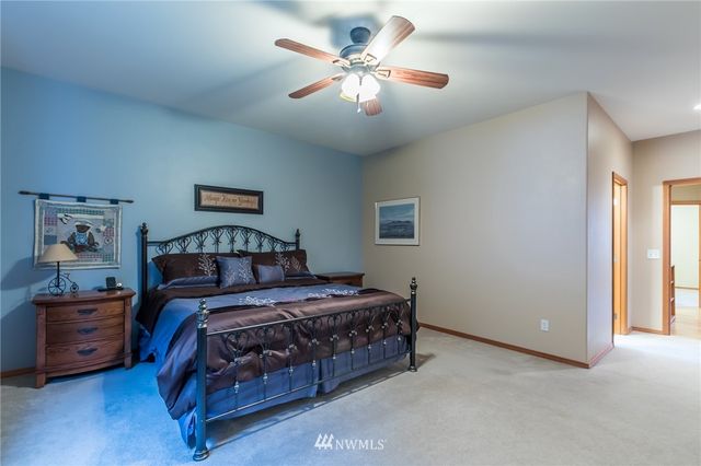 a bedroom with a bed a chandelier and a chandelier