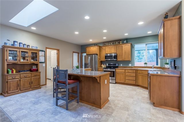 a kitchen with counter top space cabinets and stainless steel appliances