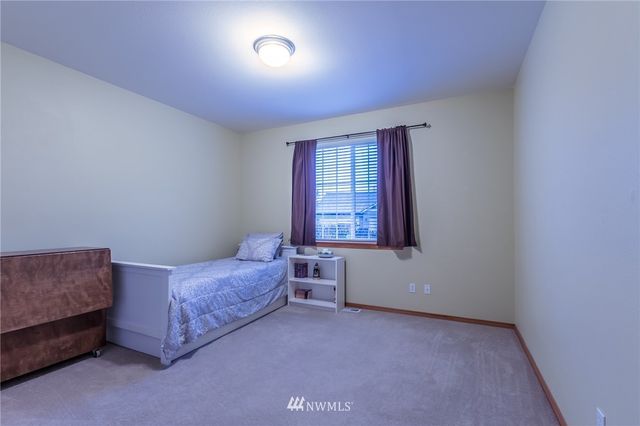 a bed room with a bed and a window