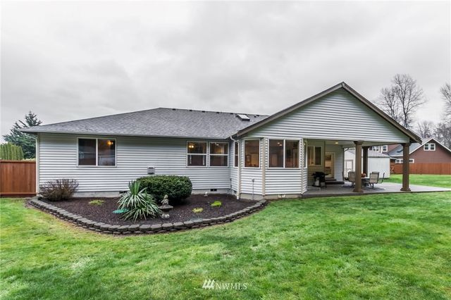 a front view of a house with a yard and porch