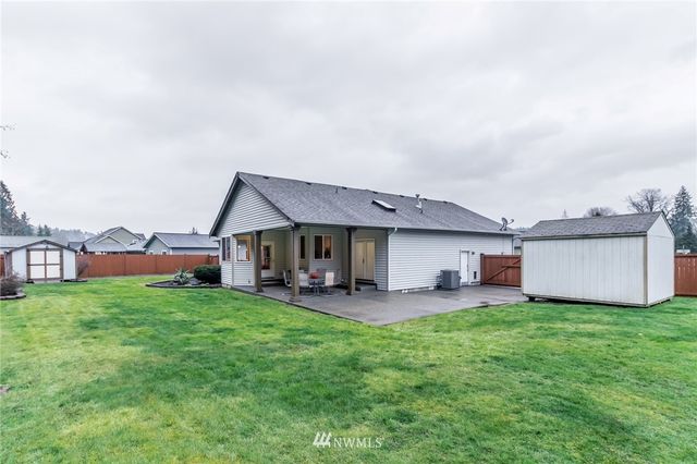 an outdoor view of a house with patio and garden
