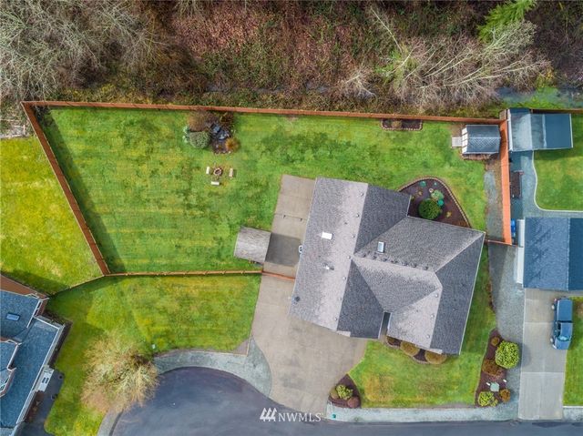 an aerial view of a house with a garden and yard
