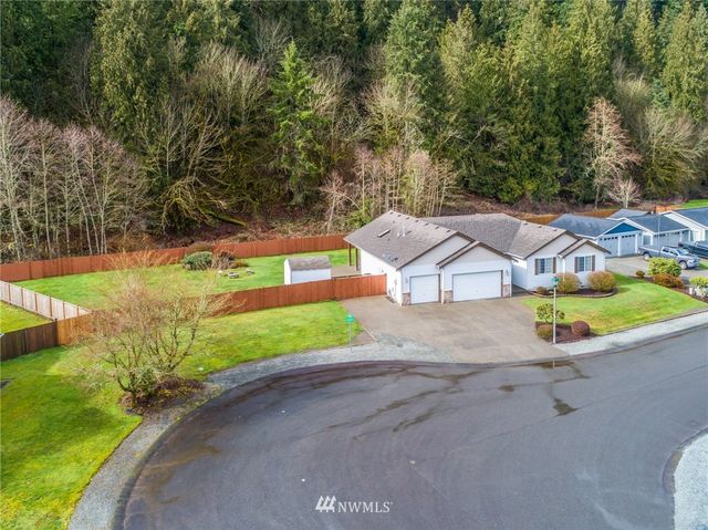 a view of a street with a barn in the background