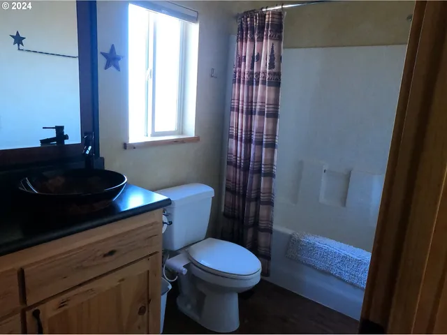 a bathroom with a toilet a sink and a window
