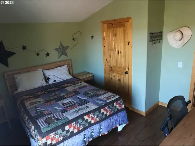 a bedroom with a bed and chair