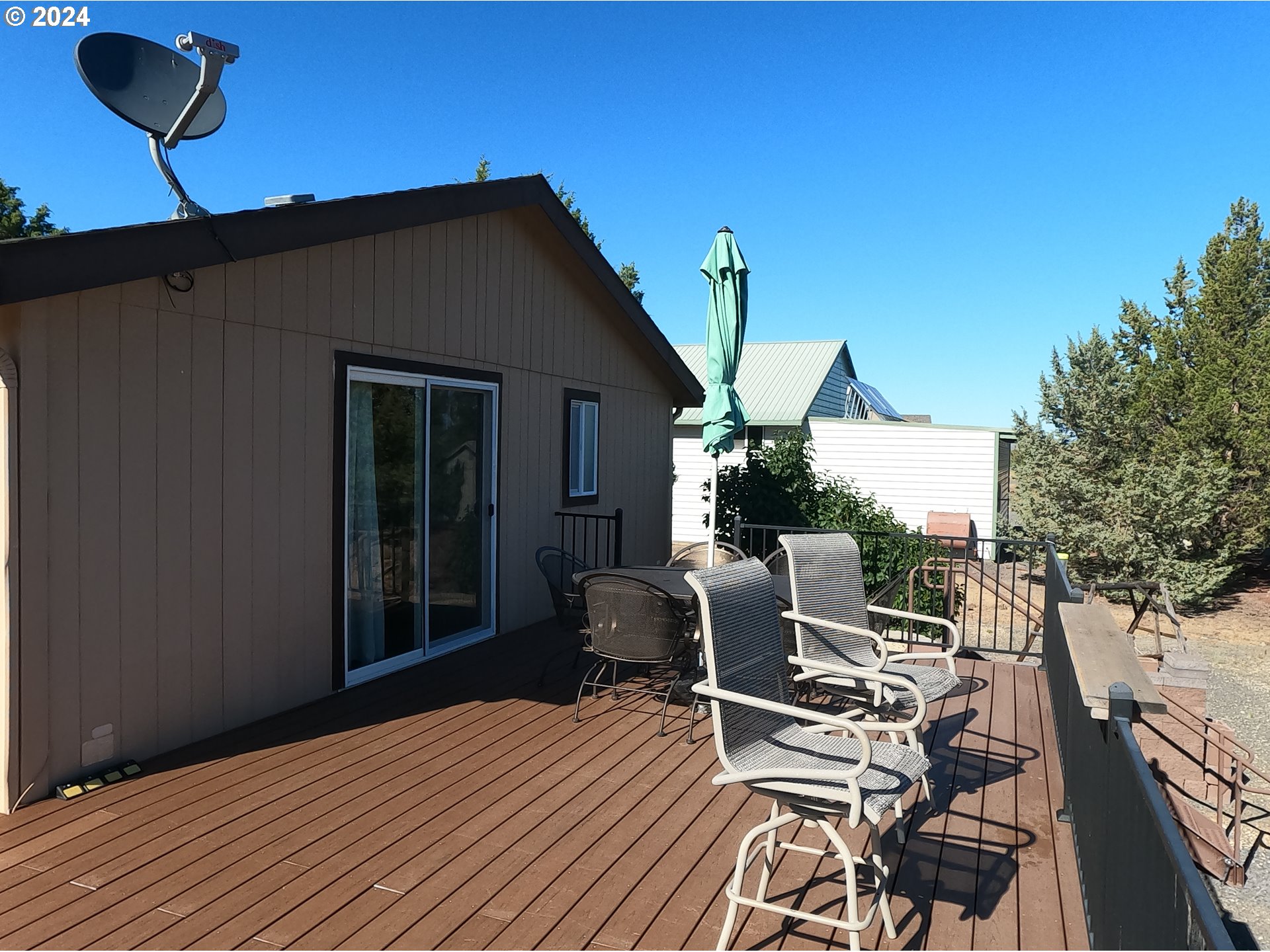 11175 Southwest Pixie Lane Culver, OR 97734 - Photo 18 of 33 a roof deck with table and chairs a barbeque