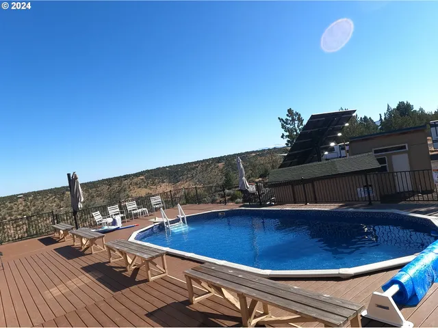 a view of a living room with kitchen island furniture and a floor to ceiling window