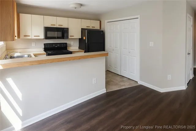 a kitchen with stainless steel appliances a refrigerator a stove top oven a sink and dishwasher