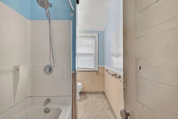 a bathroom with a tub shower vanity and a sink
