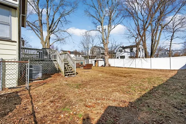 a front view of a house with a yard covered in snow