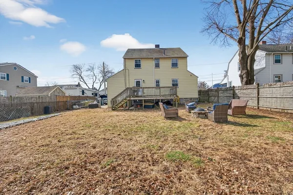 a view of a house with backyard and sitting area