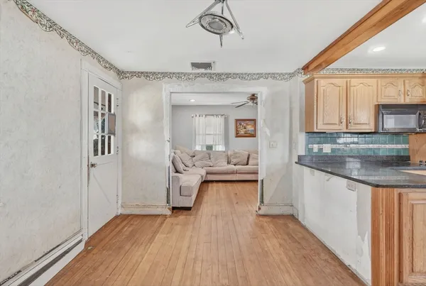 a spacious bathroom with a granite countertop sink and a mirror