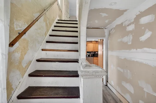 a view of entryway and hall with wooden floor