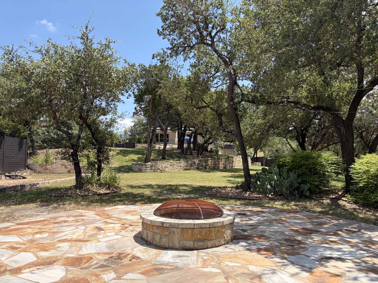 7801 Aria Loop Austin, TX 78736 - Photo 38 of 40 The gently rolling, terraced Back Yard is a perfect space to play and entertain
Firepit is perfect for roasting smores while you soak in the hill country Views
Gravel area with net is perfect for golf, soccer, baseball, or more seating