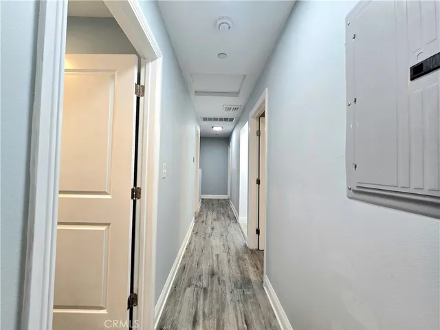 a view of hallway with wooden floor