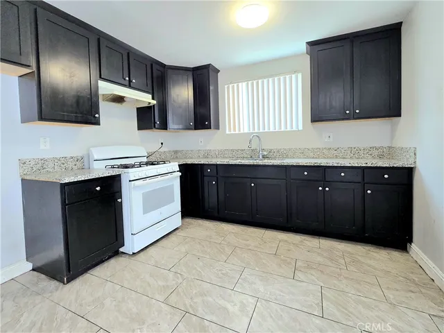 a kitchen with stainless steel appliances granite countertop a sink and cabinets