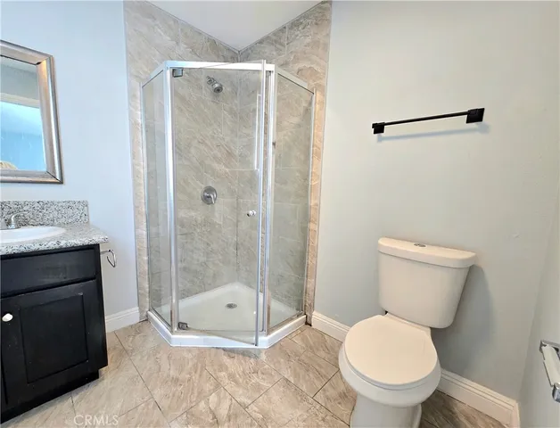 a bathroom with a toilet and a shower