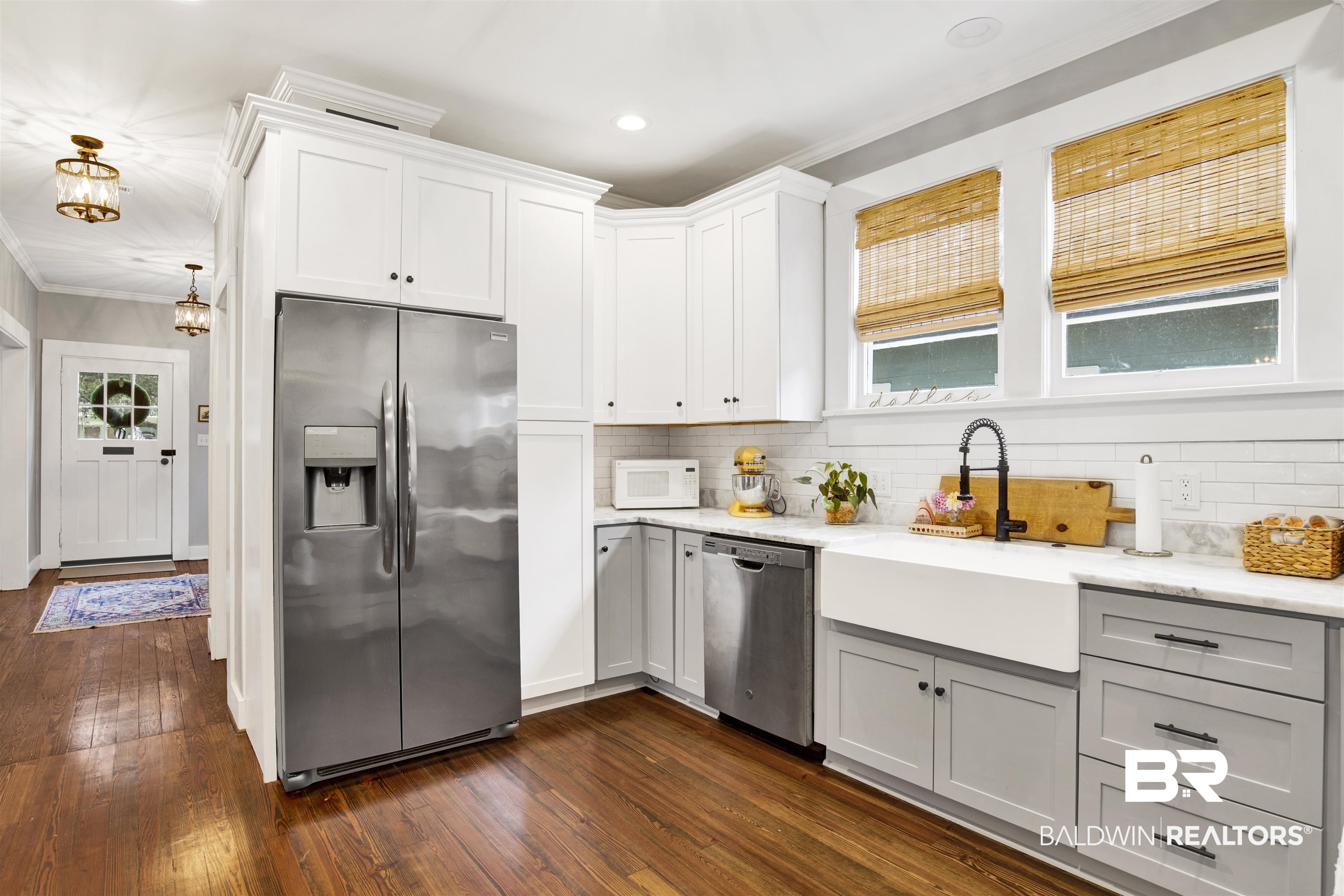 123 Macy Place Mobile, AL 36604 - Photo 29 of 35 Kitchen featuring stainless steel appliances, dark wood-style floors, light stone counters, crown molding, and backsplash