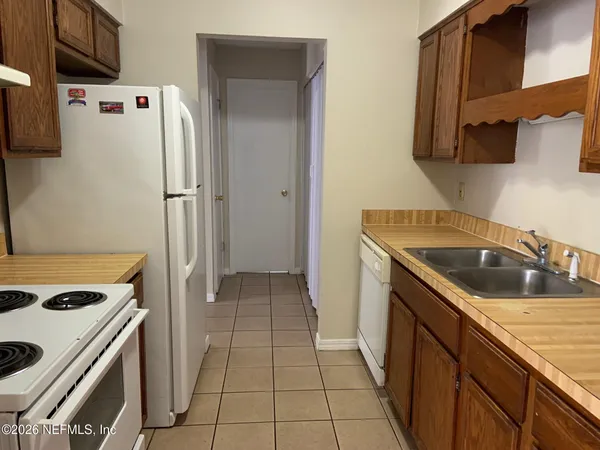 a kitchen with a refrigerator sink and stove