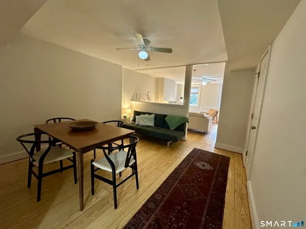 a living room with a table and a chandelier