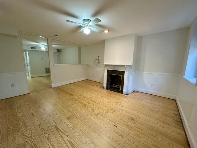 an empty room with fan and entrance