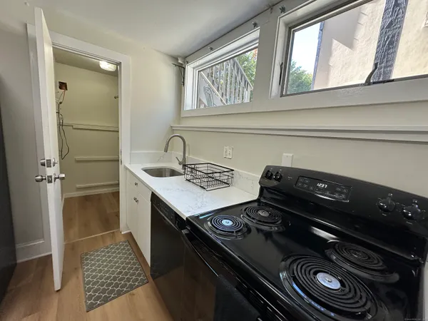 a kitchen with a stove a sink and a refrigerator