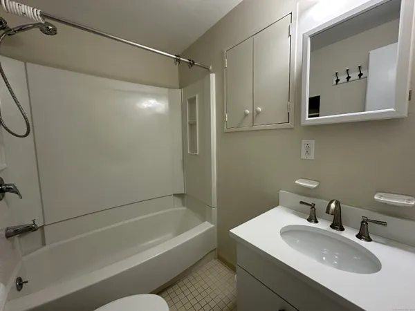 a bathroom with a sink a mirror and a bathtub