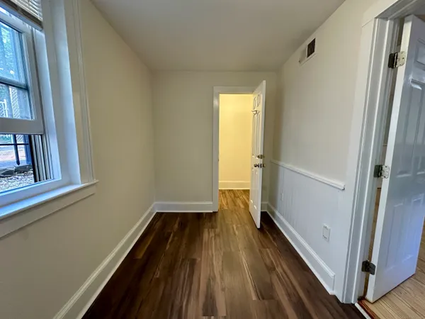 a view of a room with wooden floor and a window