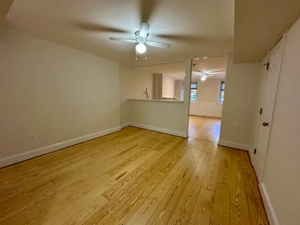 a view of empty room with wooden floor
