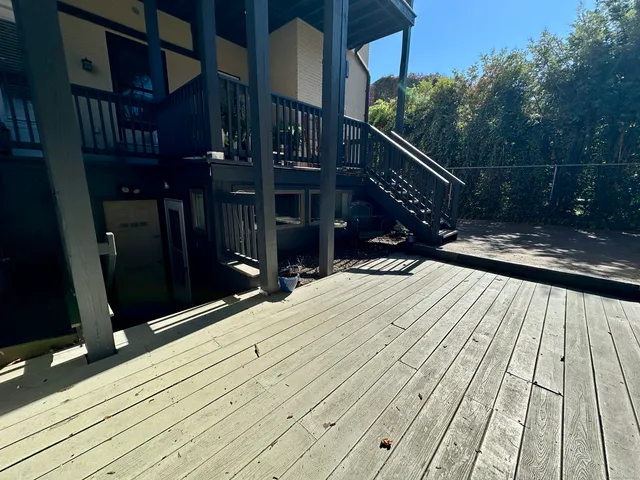 a view of balcony with wooden floor